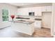 Well-appointed kitchen with white cabinetry, granite countertops, a stainless steel microwave, and a functional island at 7601 Hammond Dr, Charlotte, NC 28215