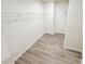 Large walk-in closet with multiple wire shelves and modern flooring, providing an organized storage solution at 7601 Hammond Dr, Charlotte, NC 28215
