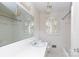All-white bathroom with tub, vanity, patterned ceiling light, and shuttered window at 761 Milton Ave, Rock Hill, SC 29730