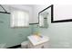 Charming bathroom featuring light green tile and classic fixtures, creating a clean and inviting space at 761 Milton Ave, Rock Hill, SC 29730