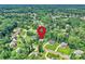 Aerial view highlighting the property's location within a lush, green neighborhood with lake access at 7916 Deerbridge St, Mint Hill, NC 28227