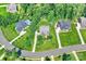 A high-angle view of the property's manicured lawn, mature trees, and proximity to neighboring houses at 7916 Deerbridge St, Mint Hill, NC 28227
