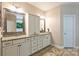 Bathroom featuring a dual vanity with granite countertops, and decorative mirrors at 7916 Deerbridge St, Mint Hill, NC 28227