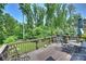 Outdoor wood deck with seating area and lush green trees at 7916 Deerbridge St, Mint Hill, NC 28227