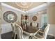 Chic dining room featuring an elegant chandelier, statement mirror, and refined furnishings at 7916 Deerbridge St, Mint Hill, NC 28227