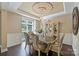 Bright dining room with decorative ceiling detail, chandelier, and large window at 7916 Deerbridge St, Mint Hill, NC 28227
