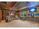 Spacious entertainment room with recliner seating and custom shelving with collectibles at 7916 Deerbridge St, Mint Hill, NC 28227