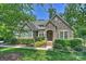 Charming home featuring stone facade, inviting front porch and professionally landscaped front yard at 7916 Deerbridge St, Mint Hill, NC 28227