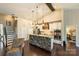 Open kitchen with stone island, hardwood floors, and seamless access to the living area at 7916 Deerbridge St, Mint Hill, NC 28227