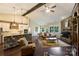 Open-concept living area featuring a stone kitchen island, fireplace, and hardwood floors at 7916 Deerbridge St, Mint Hill, NC 28227