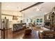 Bright living space with stone accent wall, modern kitchen, and vaulted ceiling with wooden beam at 7916 Deerbridge St, Mint Hill, NC 28227