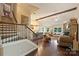 Open-concept living area with hardwood floors, stone fireplace, and a kitchen with bar seating at 7916 Deerbridge St, Mint Hill, NC 28227