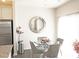 Bright dining area has a round glass table and modern chairs, complemented by a round mirrored wall decoration at 8177 Sheffield Dr, Terrell, NC 28682