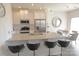 The well-lit kitchen offers a granite countertop island with bar seating and stainless steel appliances at 8177 Sheffield Dr, Terrell, NC 28682