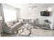 Open-concept living room features gray sectional seating, modern decor, and a granite countertop island at 8177 Sheffield Dr, Terrell, NC 28682