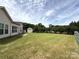 Picturesque backyard with a shed, lush green lawn, and privacy fence at 8429 Olde Stonegate Ln, Mint Hill, NC 28227