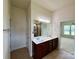 Bathroom with double sinks, modern lighting, and tile floors at 8429 Olde Stonegate Ln, Mint Hill, NC 28227