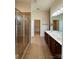 Bathroom with a glass shower, dual sinks, and tile flooring at 8429 Olde Stonegate Ln, Mint Hill, NC 28227
