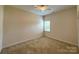 Bedroom with a ceiling fan, a neutral carpet, and natural light from the windows at 8429 Olde Stonegate Ln, Mint Hill, NC 28227