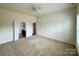Spacious bedroom with carpet and multiple entrances at 8429 Olde Stonegate Ln, Mint Hill, NC 28227