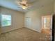 A bright bedroom featuring a ceiling fan and a closet at 8429 Olde Stonegate Ln, Mint Hill, NC 28227