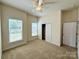 Bedroom featuring two windows, a ceiling fan and closet space at 8429 Olde Stonegate Ln, Mint Hill, NC 28227