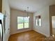 A breakfast nook with a window view and a modern chandelier at 8429 Olde Stonegate Ln, Mint Hill, NC 28227