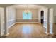 Elegant dining room with hardwood floors, a chandelier, and stylish wall accents at 8429 Olde Stonegate Ln, Mint Hill, NC 28227