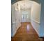 Inviting foyer with hardwood floors, chandelier, and neutral paint, leading to the front door at 8429 Olde Stonegate Ln, Mint Hill, NC 28227