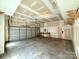 Large garage featuring overhead storage, a workbench, and ample space for vehicles at 8429 Olde Stonegate Ln, Mint Hill, NC 28227