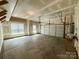 Spacious two-car garage, perfect for storage, with a roll-up door and windows at 8429 Olde Stonegate Ln, Mint Hill, NC 28227