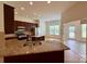 A kitchen with stainless steel appliances, granite countertops, and a spacious island with a sink at 8429 Olde Stonegate Ln, Mint Hill, NC 28227