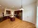 Spacious kitchen with stainless steel appliances, an island, and hardwood floors at 8429 Olde Stonegate Ln, Mint Hill, NC 28227