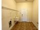 Laundry room with tiled flooring, a utility sink, and washer/dryer hookups at 8429 Olde Stonegate Ln, Mint Hill, NC 28227