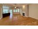 Spacious living room with hardwood floors, a ceiling fan, and a cozy fireplace for relaxing at 8429 Olde Stonegate Ln, Mint Hill, NC 28227