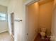 Cozy powder room featuring a toilet and warm-toned walls at 8429 Olde Stonegate Ln, Mint Hill, NC 28227