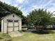 Exterior shot of storage shed with double doors, a ramp, and landscaping at 8429 Olde Stonegate Ln, Mint Hill, NC 28227