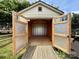 Interior view of a backyard shed featuring wood framing, storage, and accessible entry at 8429 Olde Stonegate Ln, Mint Hill, NC 28227