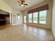 Bright sunroom with tile flooring and large windows offering a view of the backyard at 8429 Olde Stonegate Ln, Mint Hill, NC 28227