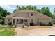 Beautiful backyard with a stone patio, pergola, and outdoor dining area at 8433 Cheverny Dr, Waxhaw, NC 28173