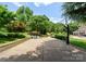 Outdoor basketball court with hoop, seating area and lush landscaping; perfect for recreation and relaxation at 8433 Cheverny Dr, Waxhaw, NC 28173
