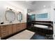 Elegant bathroom featuring a separate shower, tub, and wooden cabinets at 8433 Cheverny Dr, Waxhaw, NC 28173