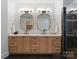 Bathroom showcasing wood cabinets, double sinks, and a walk-in shower at 8433 Cheverny Dr, Waxhaw, NC 28173