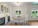 Dining area with a view of the pool featuring built-in bar with wine cooler, and glass-front cabinets at 8433 Cheverny Dr, Waxhaw, NC 28173