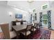 Dining room featuring high ceilings, hardwood floors, a long table with seating for eight, and stylish decor at 8433 Cheverny Dr, Waxhaw, NC 28173