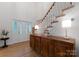 Bright foyer with hardwood floors, a wooden console table, and a staircase with white railings at 8433 Cheverny Dr, Waxhaw, NC 28173
