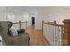 Bright hallway featuring hardwood floors and a decorative chair at 8433 Cheverny Dr, Waxhaw, NC 28173