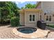 Secluded hot tub surrounded by lush greenery and a stone patio for relaxation at 8433 Cheverny Dr, Waxhaw, NC 28173