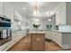 Gourmet kitchen boasts marble countertops, custom cabinets, stainless appliances, and hardwood floors at 8433 Cheverny Dr, Waxhaw, NC 28173