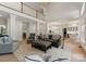 Open-concept living room with hardwood floors, high ceilings, and a view of the kitchen and dining area at 8433 Cheverny Dr, Waxhaw, NC 28173